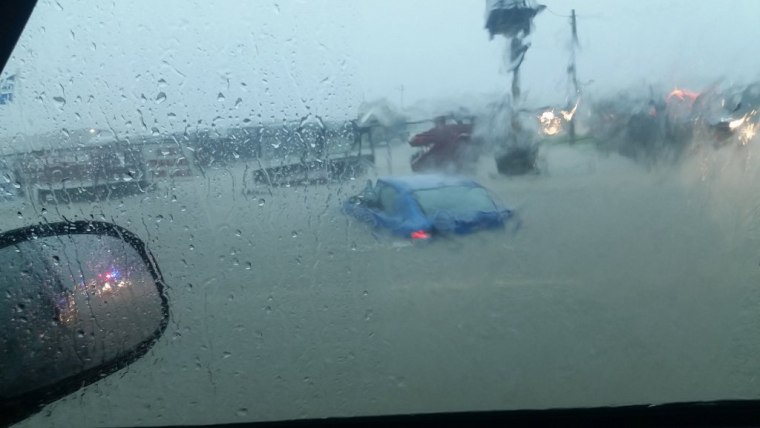 Cars are submerged in floodwaters along Highway 21 in Bryan, Texas, on May 26.