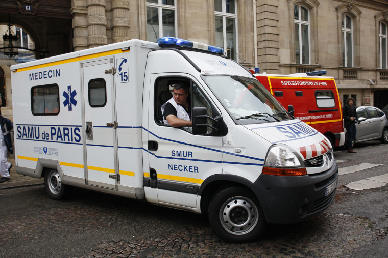 Image: An ambulance leaves a building in Paris