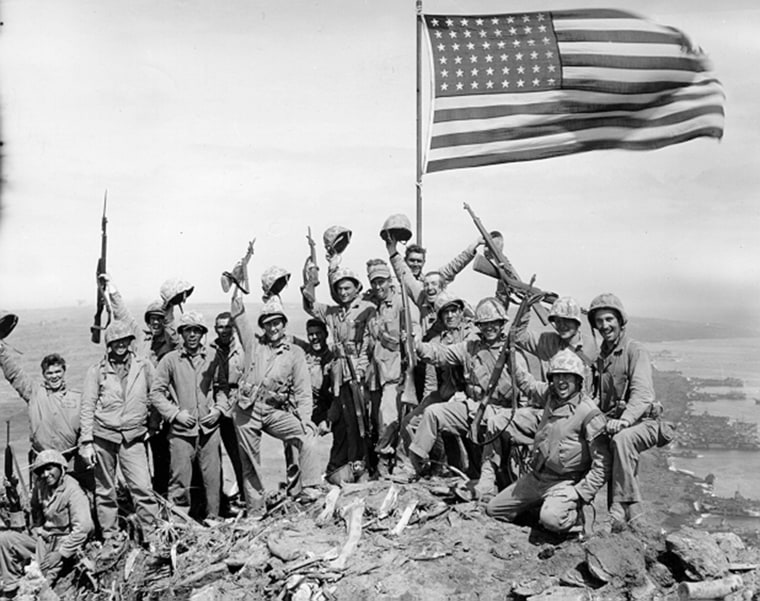 Photo taken by Army Pfc. George Burns at the summit of Mount Suribachi is nearly identical to the so-called "gung-ho" photo shot by the AP's Joe Rosenthal.