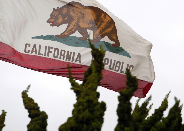 Image: File photo of the California state flag flying above City Hall in Santa Monica