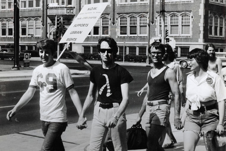 Jack Baker and Michael McConnell, the first same-sex married couple in Minnesota, participate in a Pride Parade in Minneapolis, 1974.