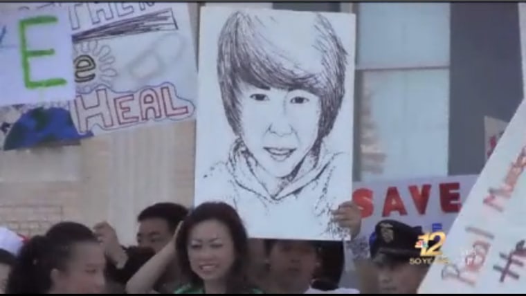 A Dylan Yang supporters hold signs during a peace march.