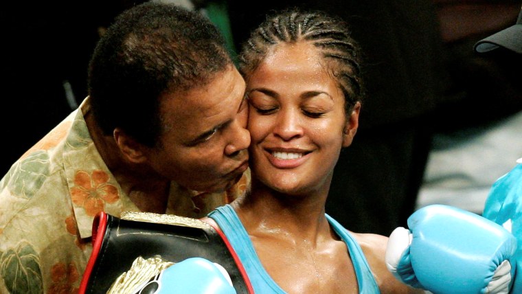 Laila Ali is kissed by her father, boxing great Muhammad Ali