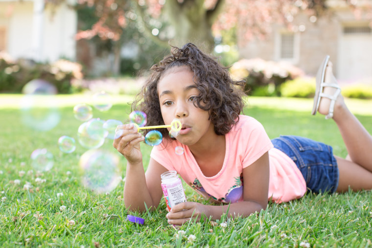 Getting down to your child's level is a sure way to get great photos of them playing with bubbles, according to Hicks.