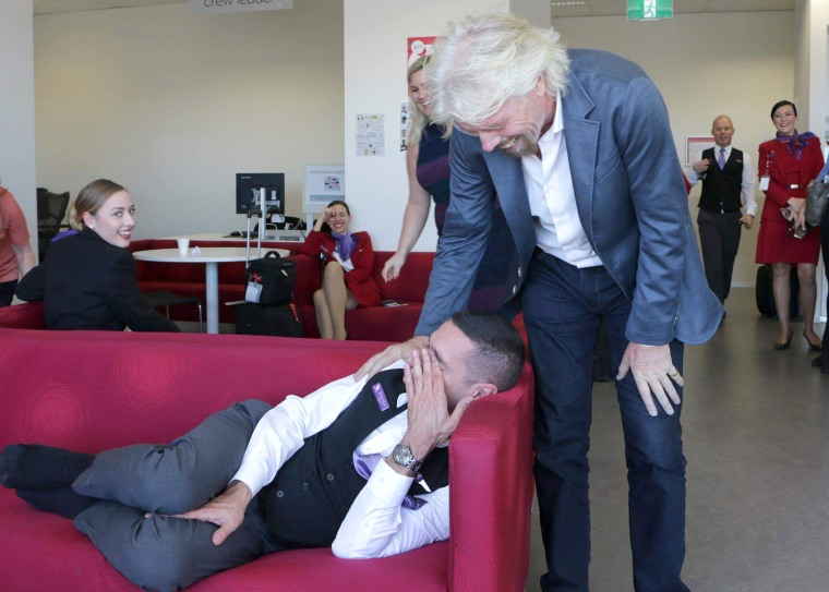 Richard Branson, mogul of Virgin everything, posed next to a sleeping employee in a fun blog post