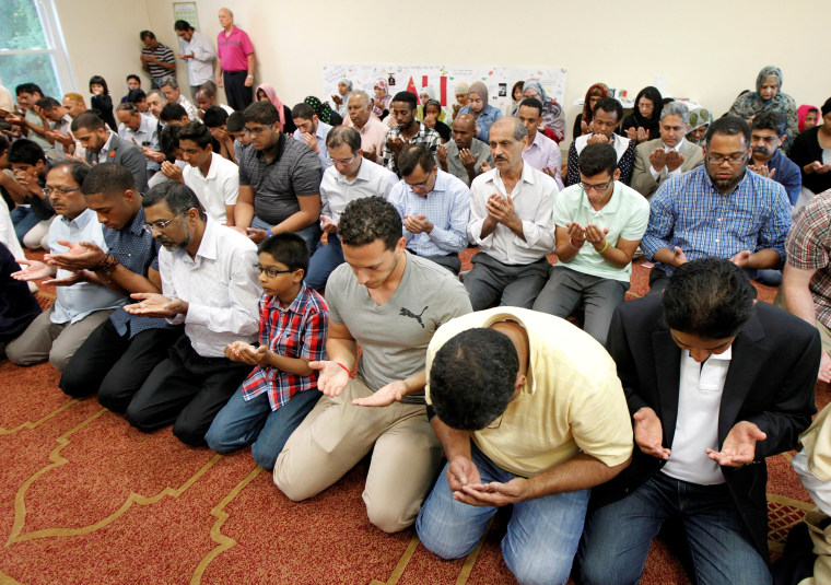 Image: Members of the Louisville Islamic Center pray together before an inter-faith service to honor Muhammad Ali.