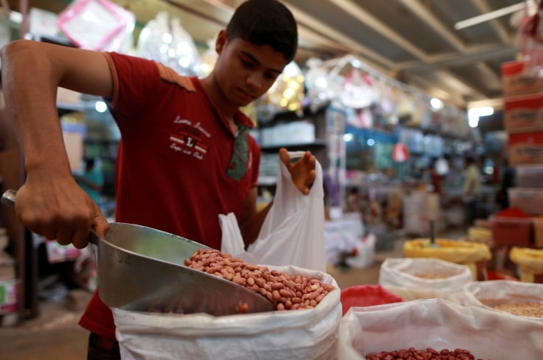 Image: A boy sells legumes at a market on the first day of Ramadan in Benghazi