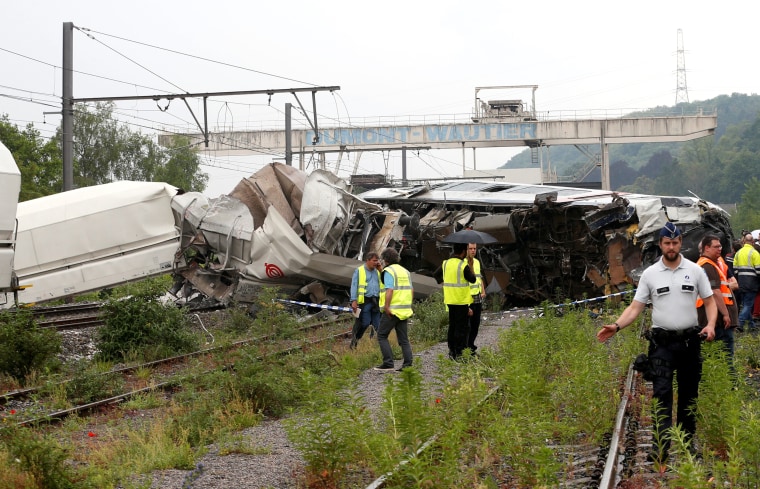 Image: The wreckage of a passenger train is pictured after it crashed into the back of a freight train in the eastern Belgian municipality of Saint-Georges-Sur-Meuse