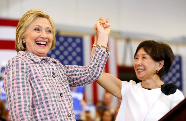 Image: U.S. Democratic presidential candidate Hillary Clinton holds up the hand of congresswoman Doris Matsui during a campaign stop in Sacramento, California