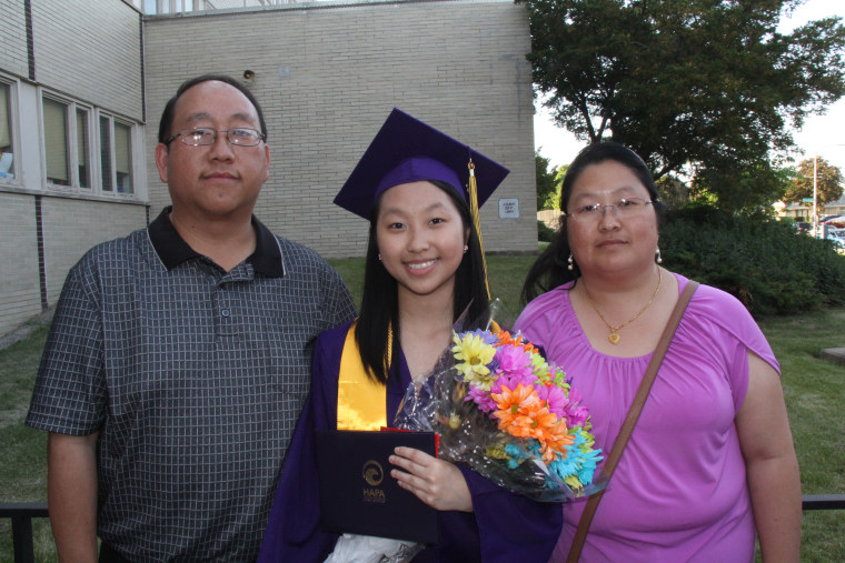 Cindy Xiong, center, with her parents Tong Xiong, right, and Mai Xiong, left.
