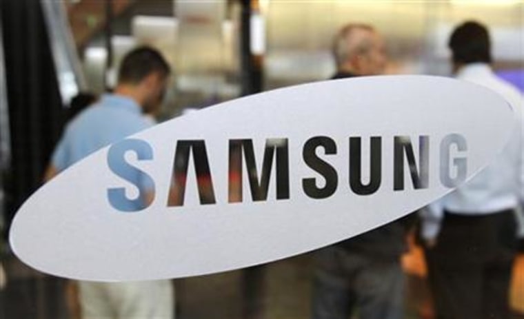 Foreign visitors look around at a showroom displaying Samsung Electronics' products at the company's headquarters in Seoul