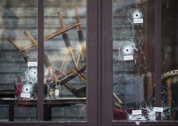 Image: Bullet holes are seen in the terrace windows of Cafe Bonne Biere