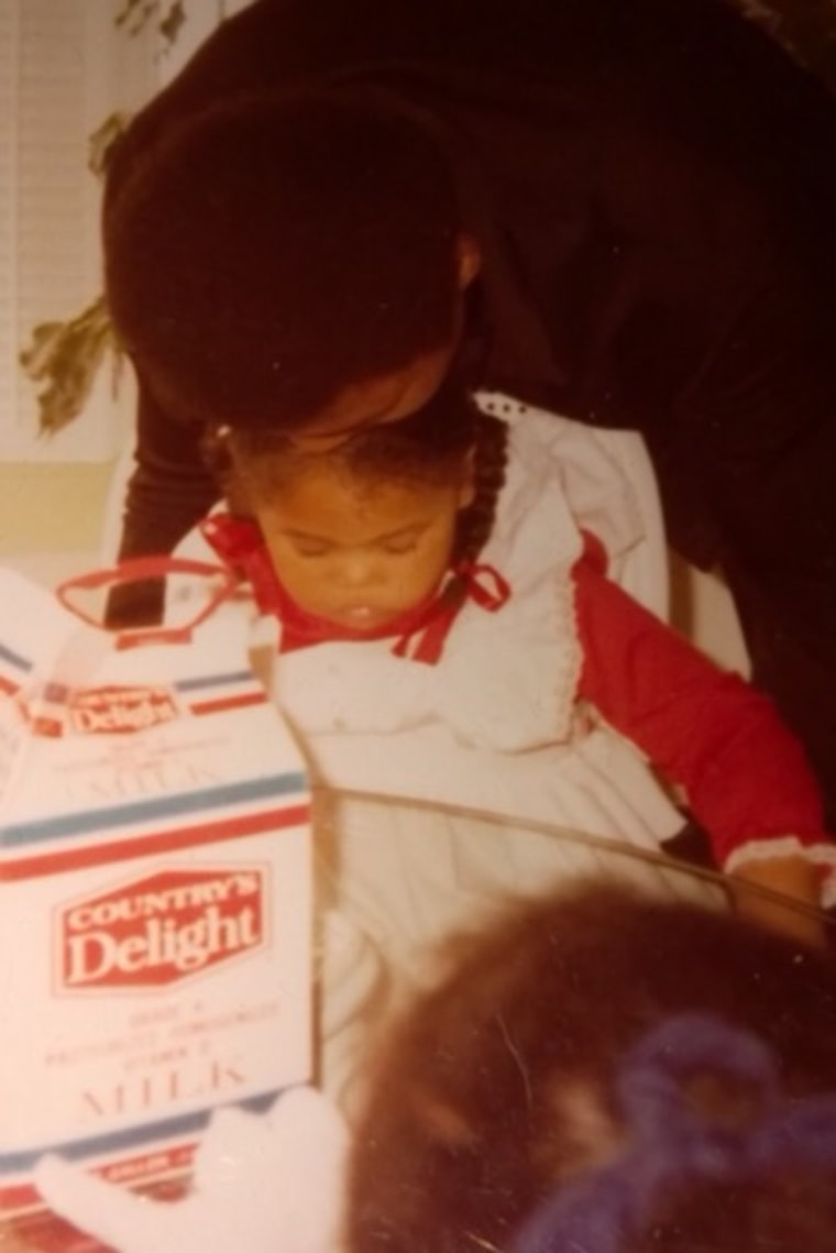 A childhood photo of Khaliah Ali, left, being kissed on the forehead by her father Muhammad Ali.