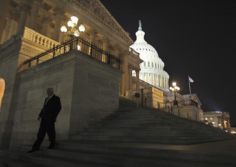 Image: A member of the U.S. House of Representatives walks down the steps from the House Chamber as he exits the U.S. Capitol in Washington