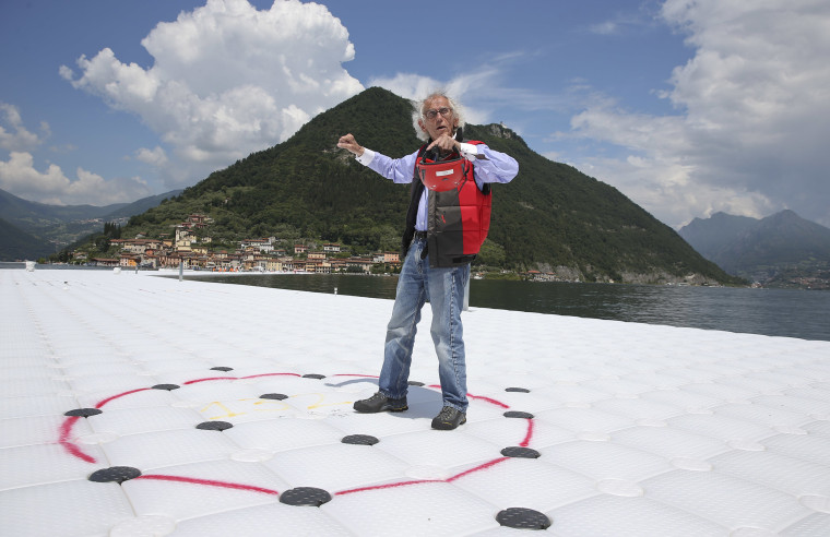 Bulgarian-born artist Christo Vladimirov Yavachev known as Christo gestures during an interview with the Associated Press on his installation 'The Floating Piers'  on the Lake Iseo, northern Italy, Tuesday, June 7, 2016. Some 200,000 floating cubes create a 3-kilometers runway to be clad in bright yellow fabric and connecting the town of Sulzano to the small island of Monte Isola on the Iseo Lake for a 16-day outdoor installation opening on June 18 through July 3. (AP Photo/Luca Bruno)
