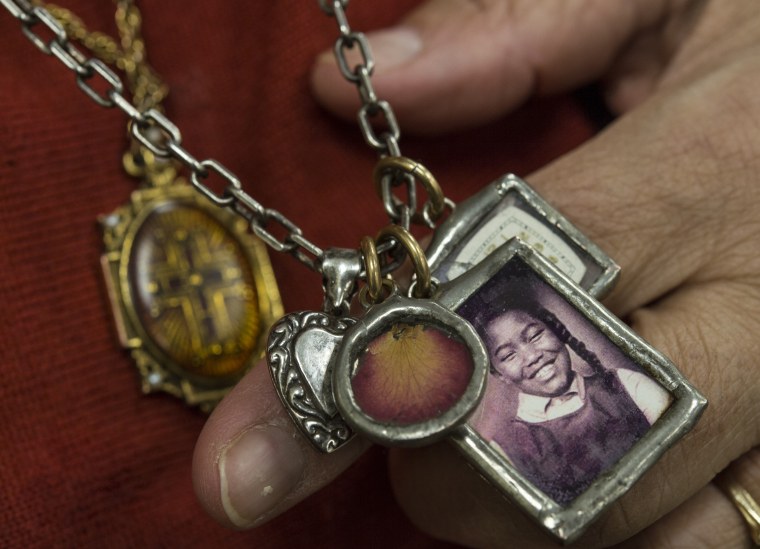Dianne Braddock, sister of Carole Robertson, one of the four girls killed in the 1963 Birmingham church bombing, shows off a necklace of trinkets before speaking to a group of middle-school students about the Civil Rights Movement on Tuesday, February 25, 2014.
