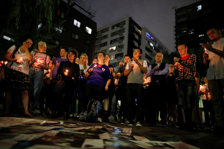 Image: People hold a candlelight vigil to mourn victims of the mass shooting at the Pulse gay nightclub in Orlando, in Tokyo, Japan