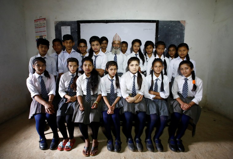 Image: His classmates have dubbed him 'Baa,' which means father in Nepali.