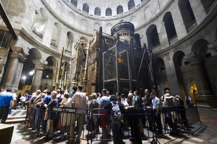 Image: Christian pilgrims wait in line to visit the tomb of Jesus Christ in the Church of Holy Sepulcher