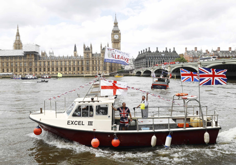 Image: Part of a flotilla of fishing vessels campaigning to leave the European Union sails past Parliament on the river Thames in London