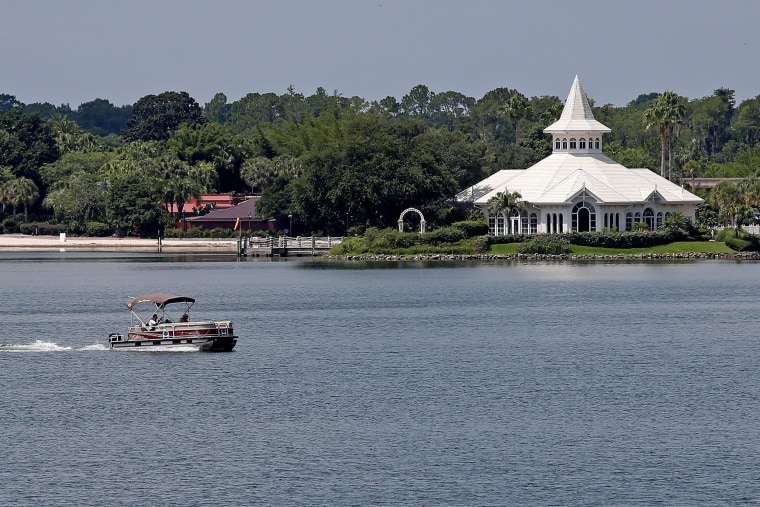 Image: A search boat is seen in the Seven Seas Lagoon, in front of a beach at the Grand Floridian, at the Walt Disney World resort in Orlando, Florida
