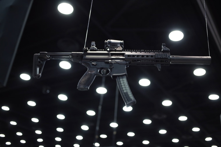 Image: A SIG MPX hangs from the ceiling at the SIG Sauer GmbH on the exhibit floor