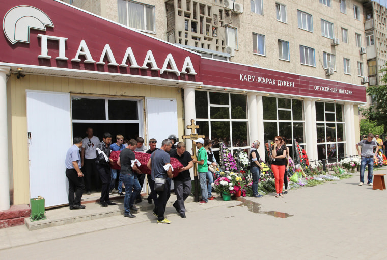 Image: Mourners carry a coffin containing the body of Andrey Maksimenko