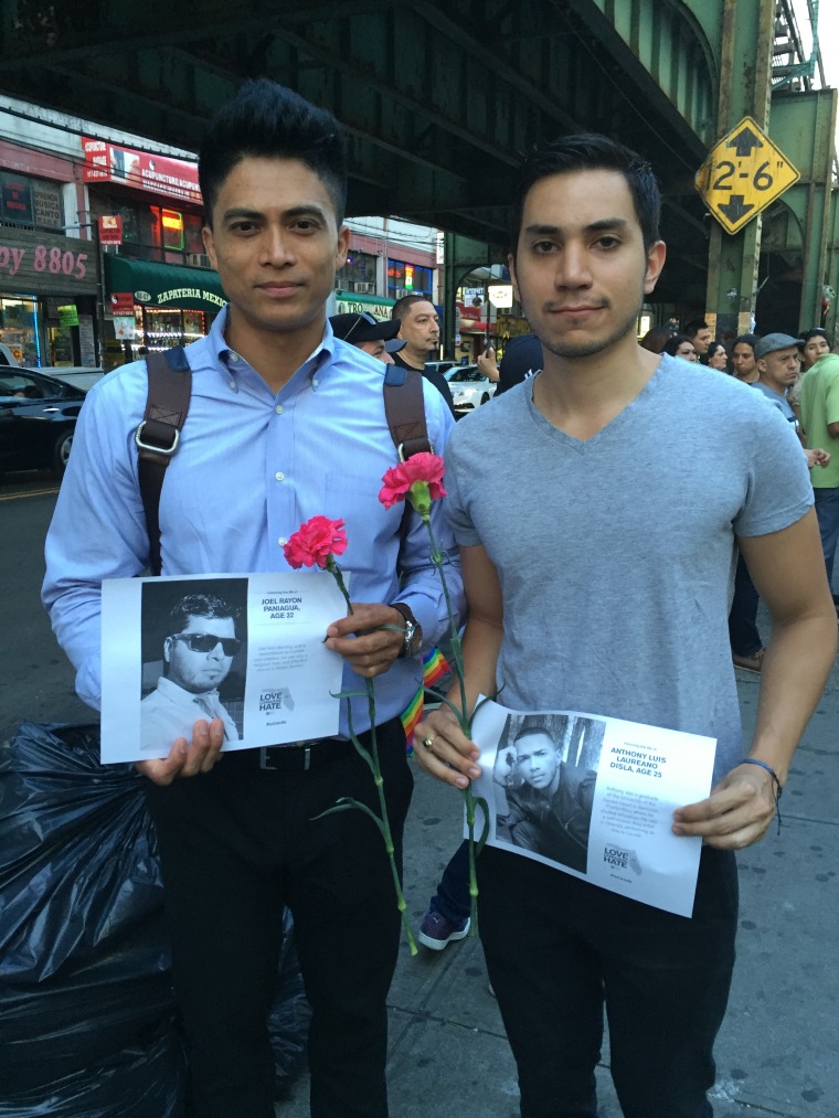 Marchers hold photos of Orlando Shooting victims.