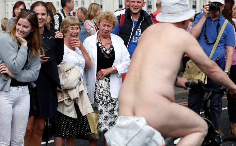 Image: Women react as they watch cyclists participate in the World Naked Bike Ride, which organisers say is a protest against reliance on cars and oil, on Westminster Bridge London, Britain