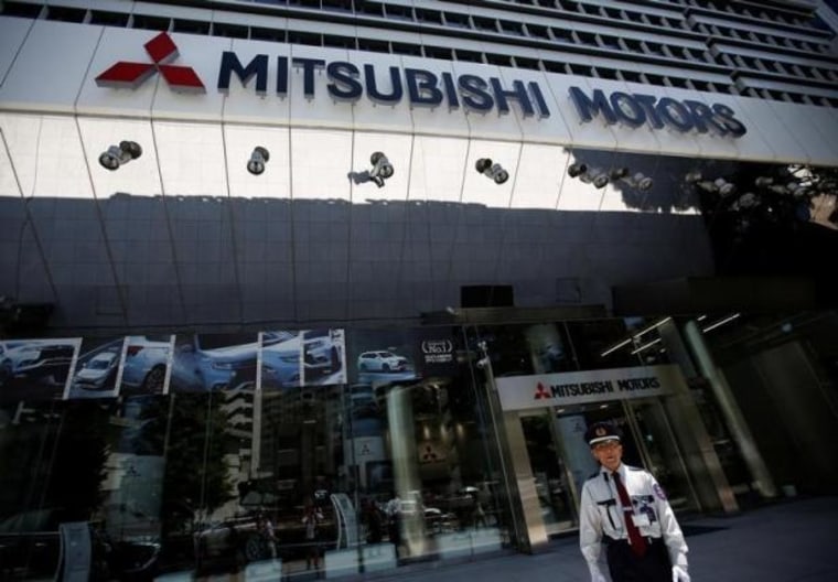 A security personnel walks in front of Mitsubishi Motors Corp's headquarters in Tokyo, Japan