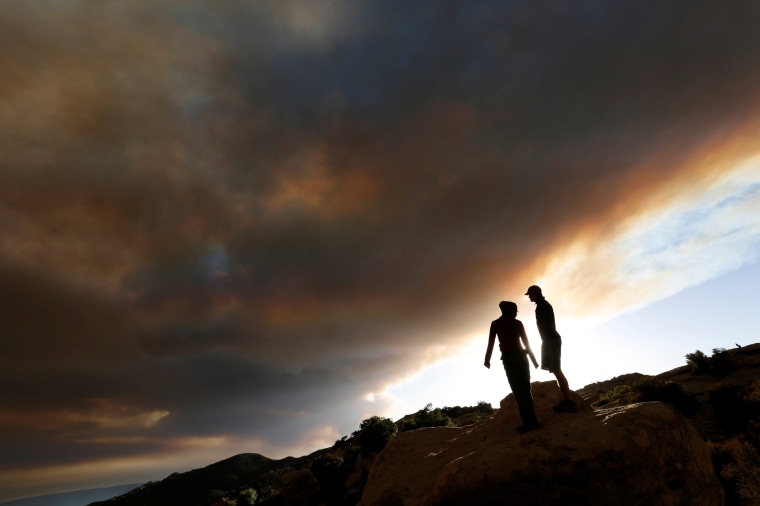 Image: Yom and Martin watch as smoke rises from the so-called \"Sherpa Fire\" in the hills near Santa Barbara