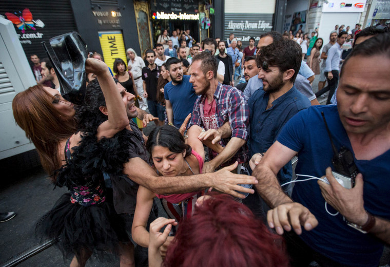 Image: LGBT rights activists struggle with plainclothes police officers before a Gay Pride Parade in central Istanbul