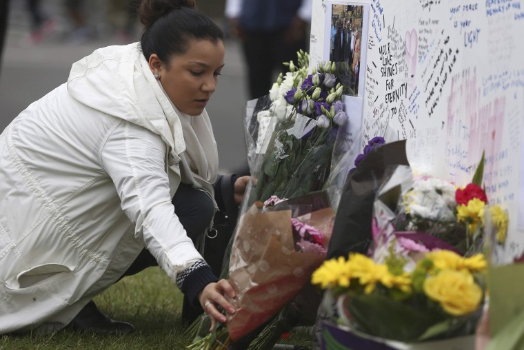 Image: A woman places a tribute for murdered Labour Party MP Jo Cox at Parliament Square in London