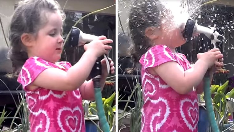 little girl with garden hose