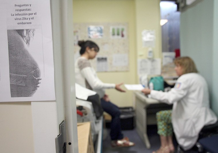 A flyer that reads, "Questions and answers: Zica virus infection during pregnancy" is seen posted outside a doctor's office, at a public hospital in San Juan