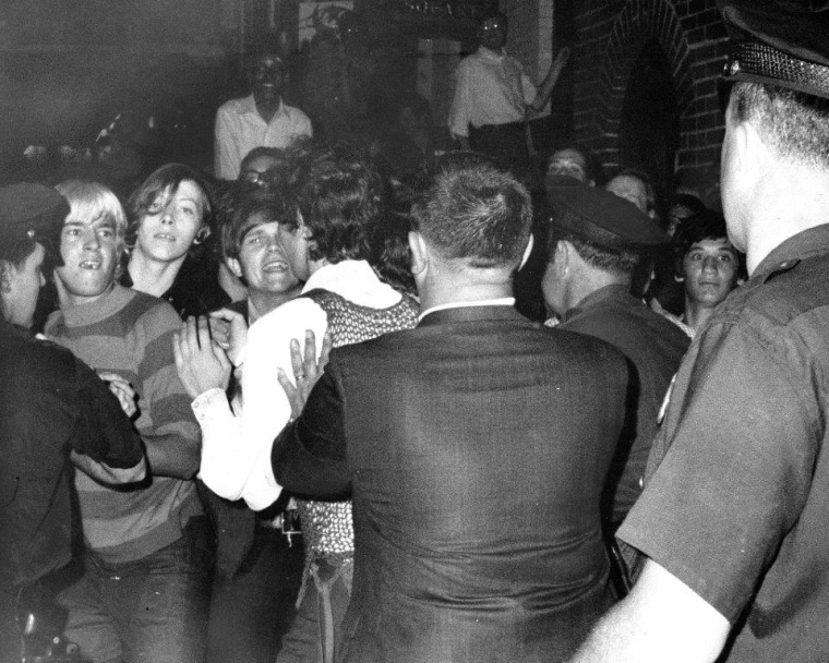 Stonewall Inn nightclub raid on June 28, 1969. Crowd attempts to impede police arrest outside the Stonewall Inn on Christopher Street in Greenwich Village.