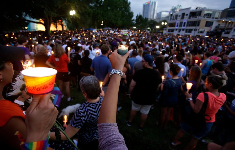 Supporters of the victims of the recent mass shooting at the Pulse nightclub hold candles while attending a vigil at Lake Eola Park, Sunday, June 19, 2016, Orlando, Fla. Tens of thousands of people attended the vigil.