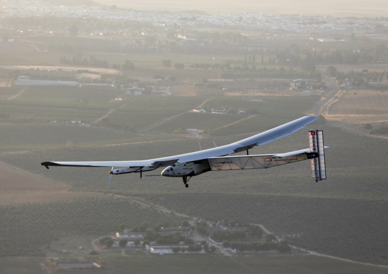 Image: The solar-powered plane Solar Impulse 2 is pictured before landing at San Pablo airport in Seville, southern Spain