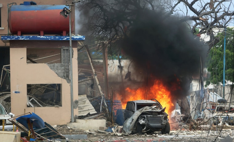 Image: A vehicle burns at the scene of a suicide bomb attack outside Nasahablood hotel in Somalia's capital Mogadishu