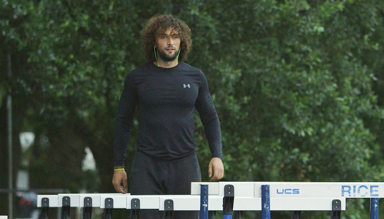 Mohammed al-Khatib warms up on the hurdles at Rice University in Houston.