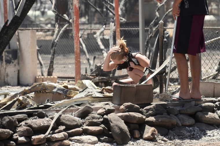 Image: Brittany Thompson cries after finding a deceased dog at a burned down residence after the Erskine Fire burned through South Lake, California