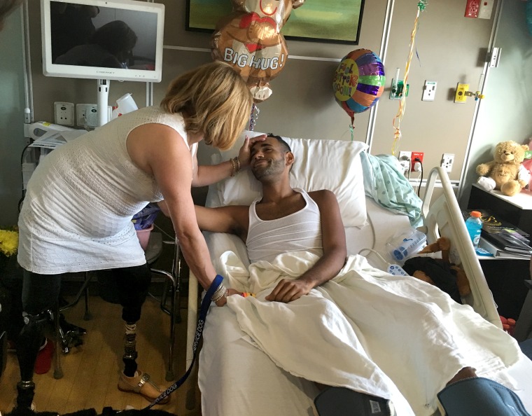 Angel Colon, Pulse shooting survivor is comforted by Boston bombing survivor Celeste Corcoran in his hospital room at Orlando Regional Medical Center.