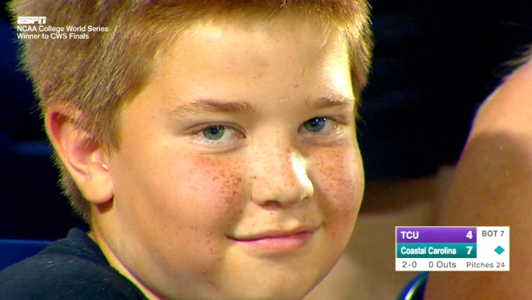 Kid stares down camera at ballgame