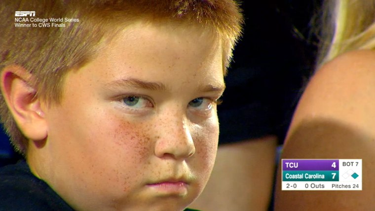 Kid stares down camera at ballgame