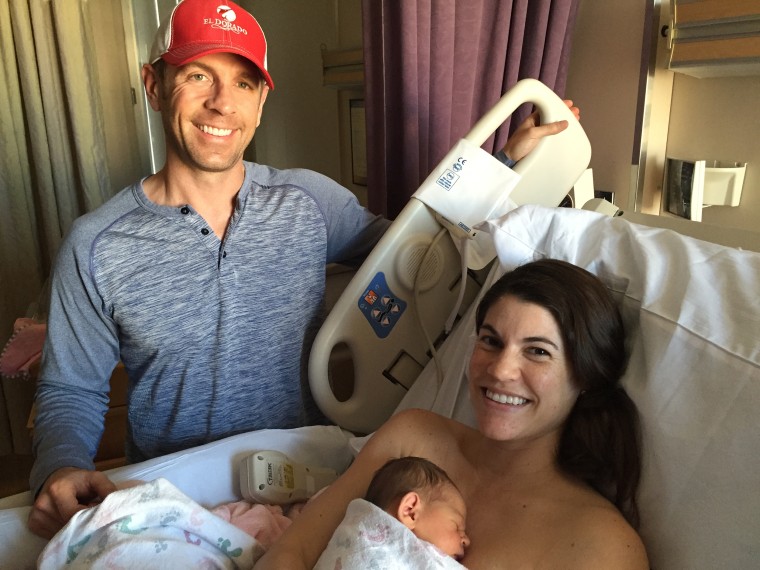Sarah Mariuz with her husband, Nick, and their newborn baby.