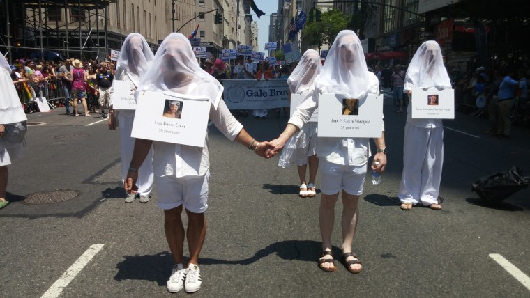 A group called 49 Humans honors the victims of the Orlando shooting and walks in solidarity with Gays Against Guns in the 2016 NYC Pride March.
