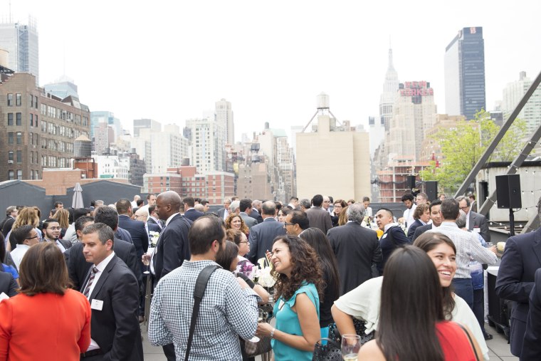 Members of The Alumni Society who attended the annual leadership summit gather on the rooftop of Hudson Mercantile for a cocktail hour.