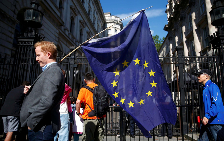 Image: A man carries a EU flag after Britain voted to leave the European Union
