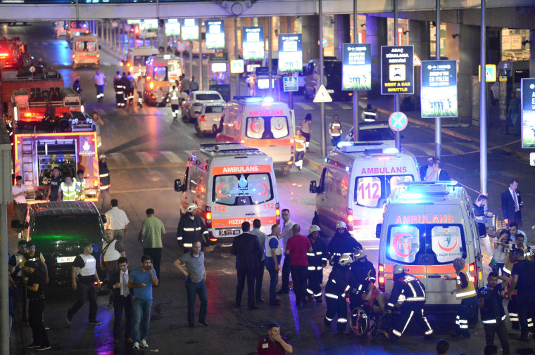 Image: Paramedics help casualties outside Turkey's largest airport, Istanbul Ataturk, Turkey, following a blast