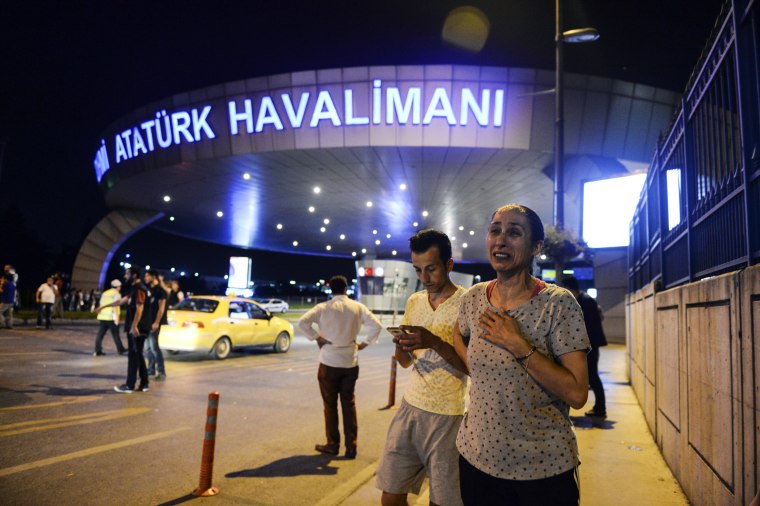 Image: People stand outside Istanbul's Ataturk airport